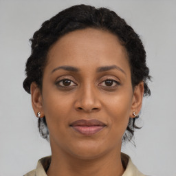 Joyful black young-adult female with short  brown hair and brown eyes