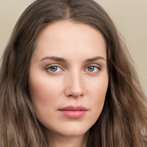 Joyful white young-adult female with long  brown hair and green eyes