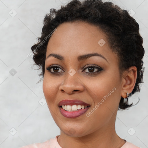 Joyful black young-adult female with short  brown hair and brown eyes