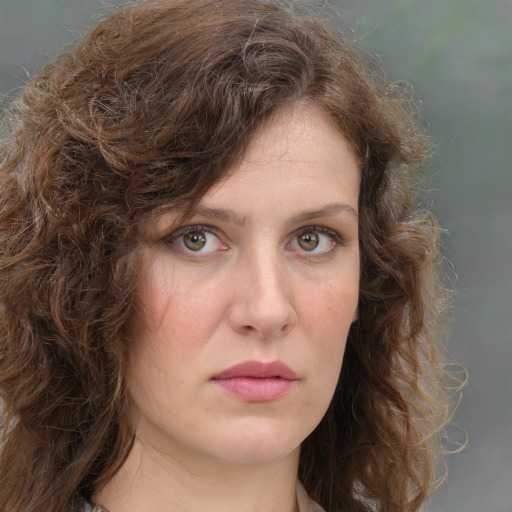 Neutral white young-adult female with long  brown hair and green eyes