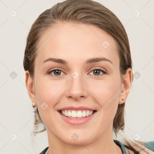 Joyful white young-adult female with medium  brown hair and green eyes