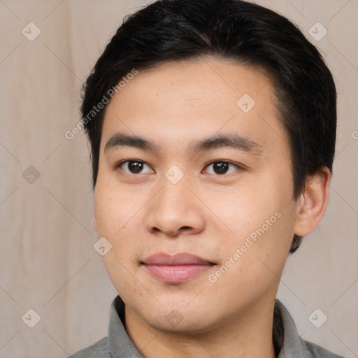 Joyful asian young-adult male with medium  brown hair and brown eyes