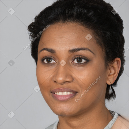 Joyful black young-adult female with short  black hair and brown eyes