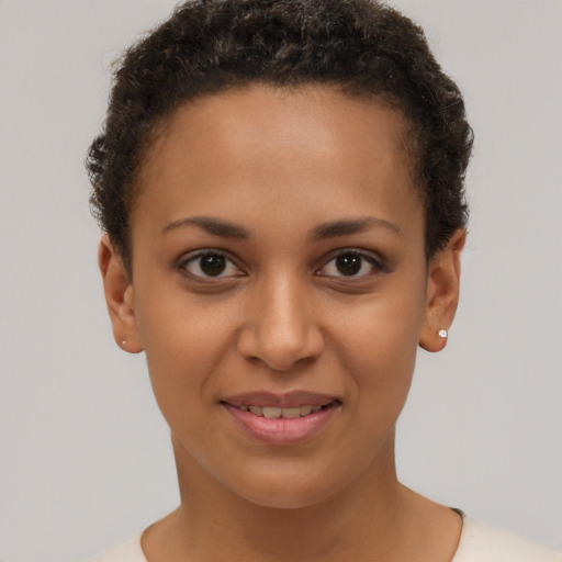 Joyful latino young-adult female with short  brown hair and brown eyes