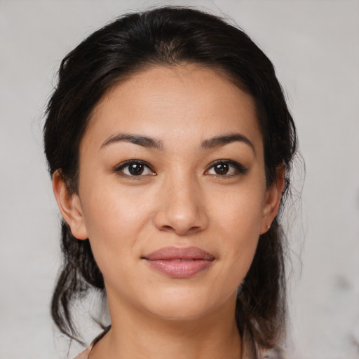 Joyful latino young-adult female with medium  brown hair and brown eyes