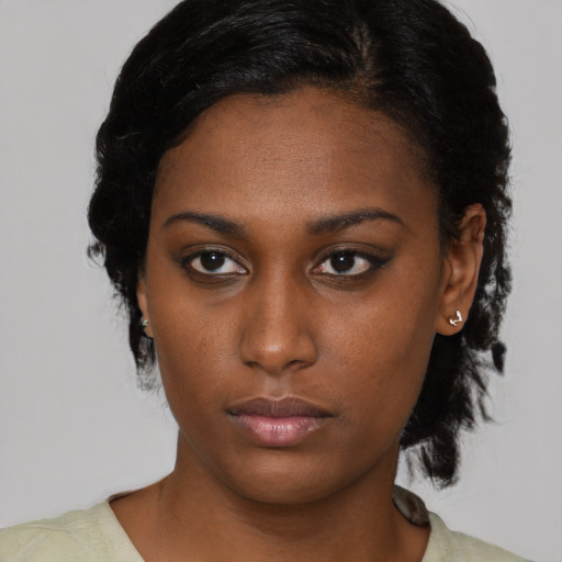 Neutral black young-adult female with medium  black hair and brown eyes