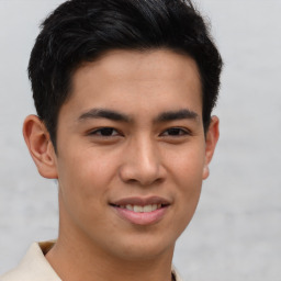 Joyful asian young-adult male with short  brown hair and brown eyes