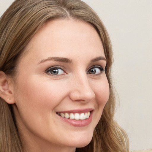 Joyful white young-adult female with long  brown hair and brown eyes