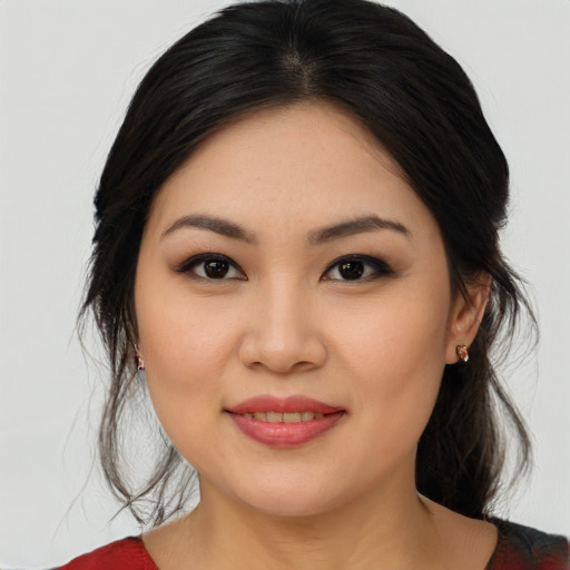 Joyful asian young-adult female with medium  brown hair and brown eyes
