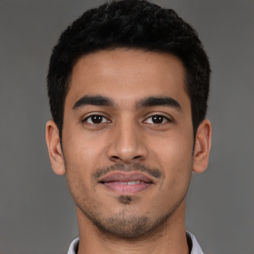 Joyful latino young-adult male with short  black hair and brown eyes