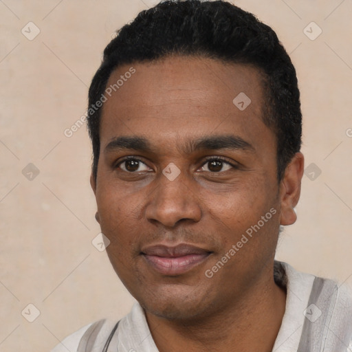 Joyful black young-adult male with short  black hair and brown eyes