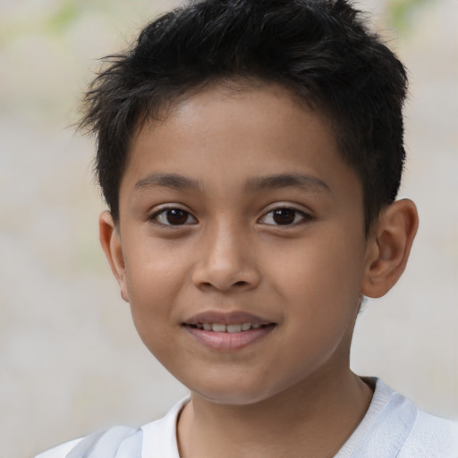 Joyful latino child male with short  brown hair and brown eyes