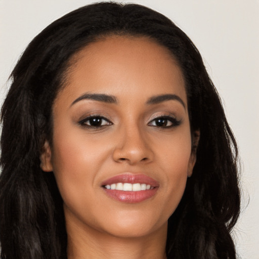 Joyful latino young-adult female with long  brown hair and brown eyes