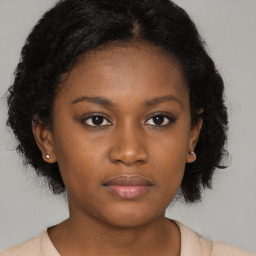 Neutral black young-adult female with medium  brown hair and brown eyes