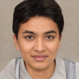 Joyful latino young-adult male with short  brown hair and brown eyes