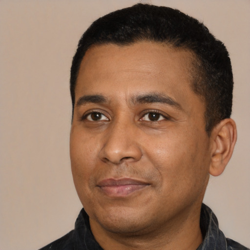 Joyful black adult male with short  black hair and brown eyes