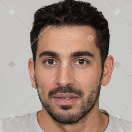 Joyful white young-adult male with short  black hair and brown eyes