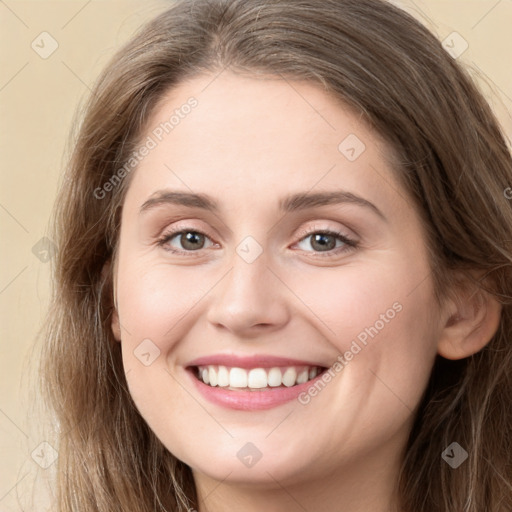 Joyful white young-adult female with long  brown hair and grey eyes