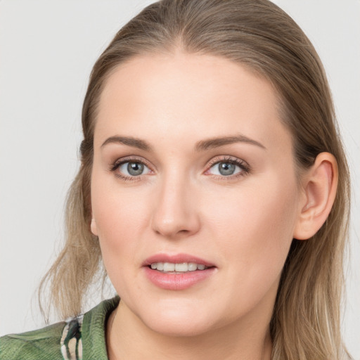 Joyful white young-adult female with long  brown hair and blue eyes