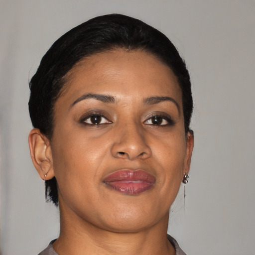 Joyful latino young-adult female with short  black hair and brown eyes