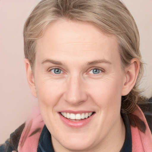 Joyful white adult female with medium  brown hair and blue eyes