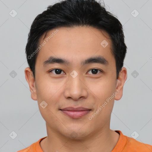 Joyful asian young-adult male with short  black hair and brown eyes