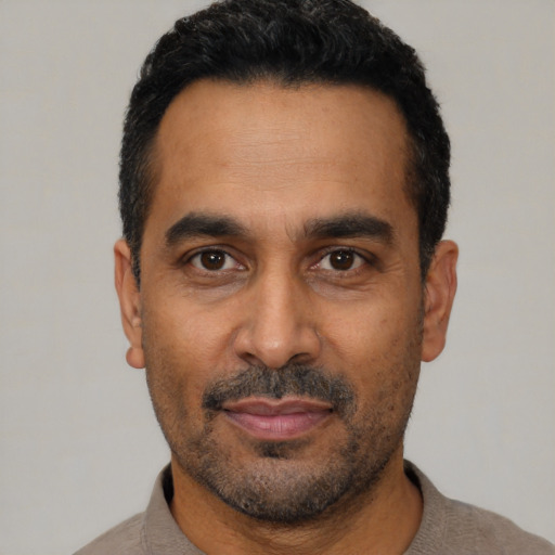 Neutral black adult male with short  black hair and brown eyes