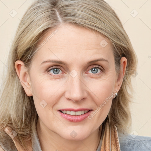 Joyful white adult female with medium  brown hair and blue eyes