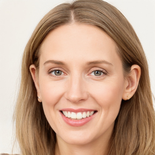 Joyful white young-adult female with long  brown hair and grey eyes