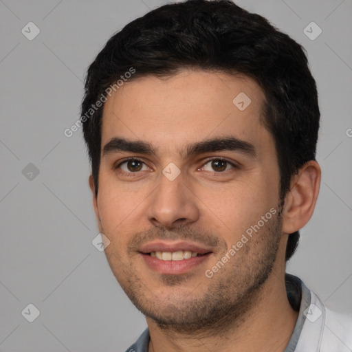 Joyful white young-adult male with short  black hair and brown eyes