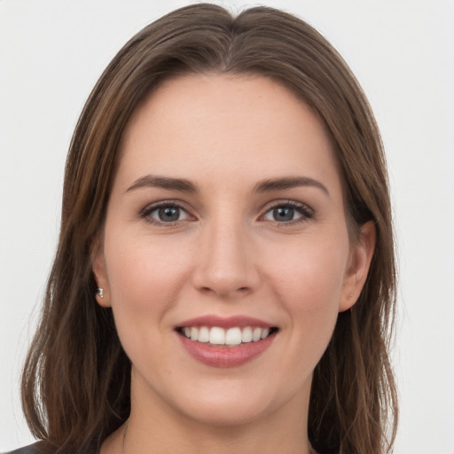 Joyful white young-adult female with long  brown hair and grey eyes