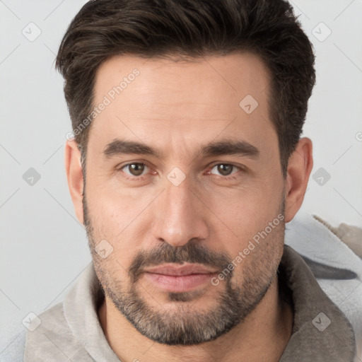 Joyful white adult male with short  brown hair and brown eyes