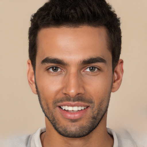 Joyful white young-adult male with short  brown hair and brown eyes