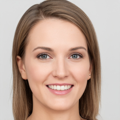 Joyful white young-adult female with long  brown hair and grey eyes