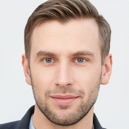 Joyful white young-adult male with short  brown hair and grey eyes