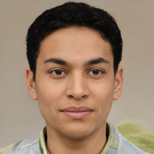 Joyful latino young-adult male with short  black hair and brown eyes