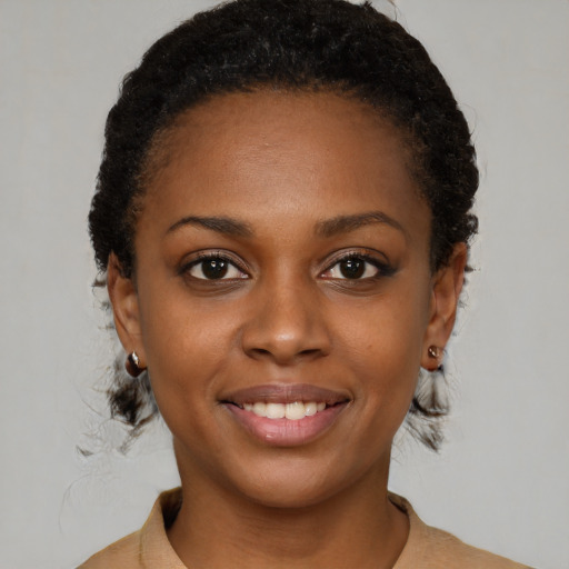 Joyful black young-adult female with short  brown hair and brown eyes