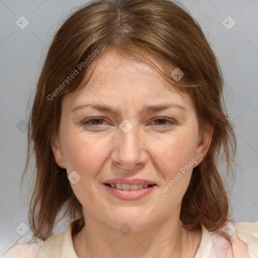 Joyful white adult female with medium  brown hair and grey eyes