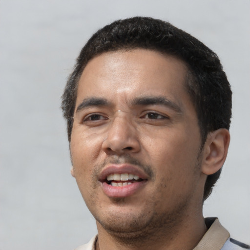Joyful white young-adult male with short  black hair and brown eyes