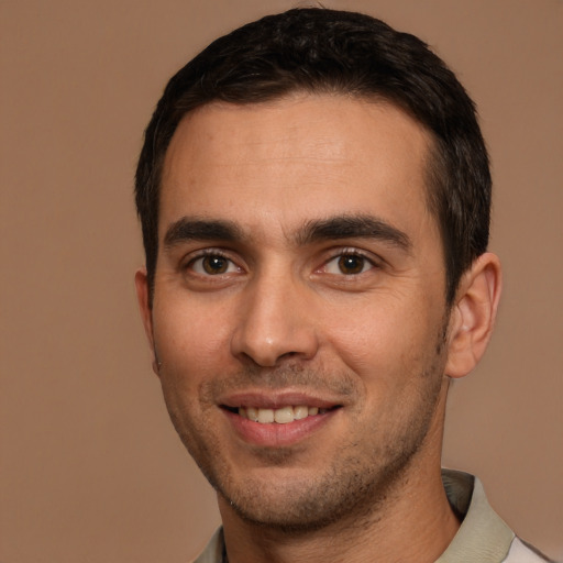 Joyful white young-adult male with short  brown hair and brown eyes