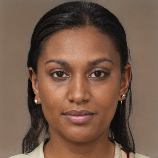 Joyful black young-adult female with medium  brown hair and brown eyes
