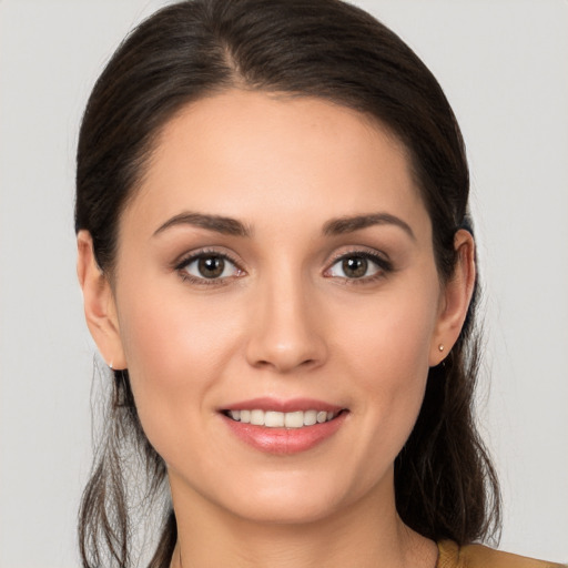 Joyful white young-adult female with long  brown hair and brown eyes