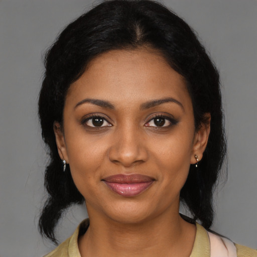 Joyful black young-adult female with medium  brown hair and brown eyes