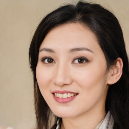 Joyful asian young-adult female with long  brown hair and brown eyes