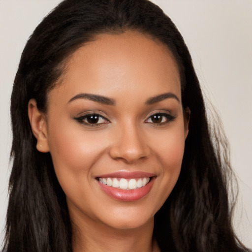 Joyful latino young-adult female with long  brown hair and brown eyes