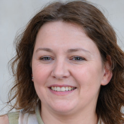 Joyful white adult female with long  brown hair and brown eyes