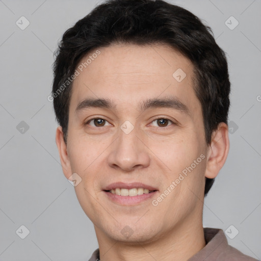 Joyful white young-adult male with short  black hair and brown eyes