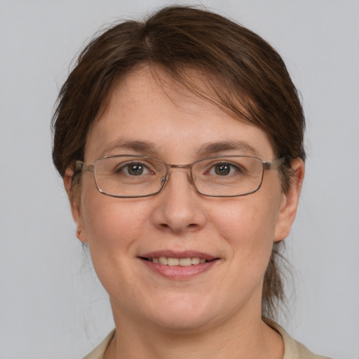 Joyful white adult female with medium  brown hair and grey eyes