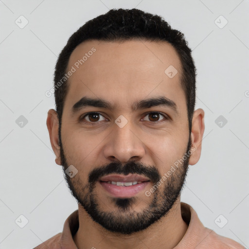 Joyful latino young-adult male with short  black hair and brown eyes