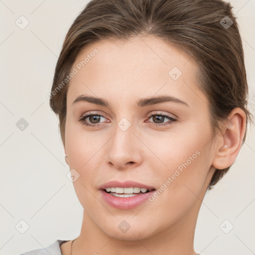 Joyful white young-adult female with short  brown hair and grey eyes